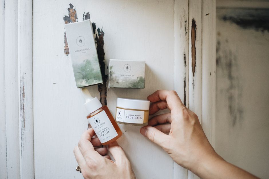 Flat lay of artisanal skincare products on a rustic surface, showcasing natural beauty ess